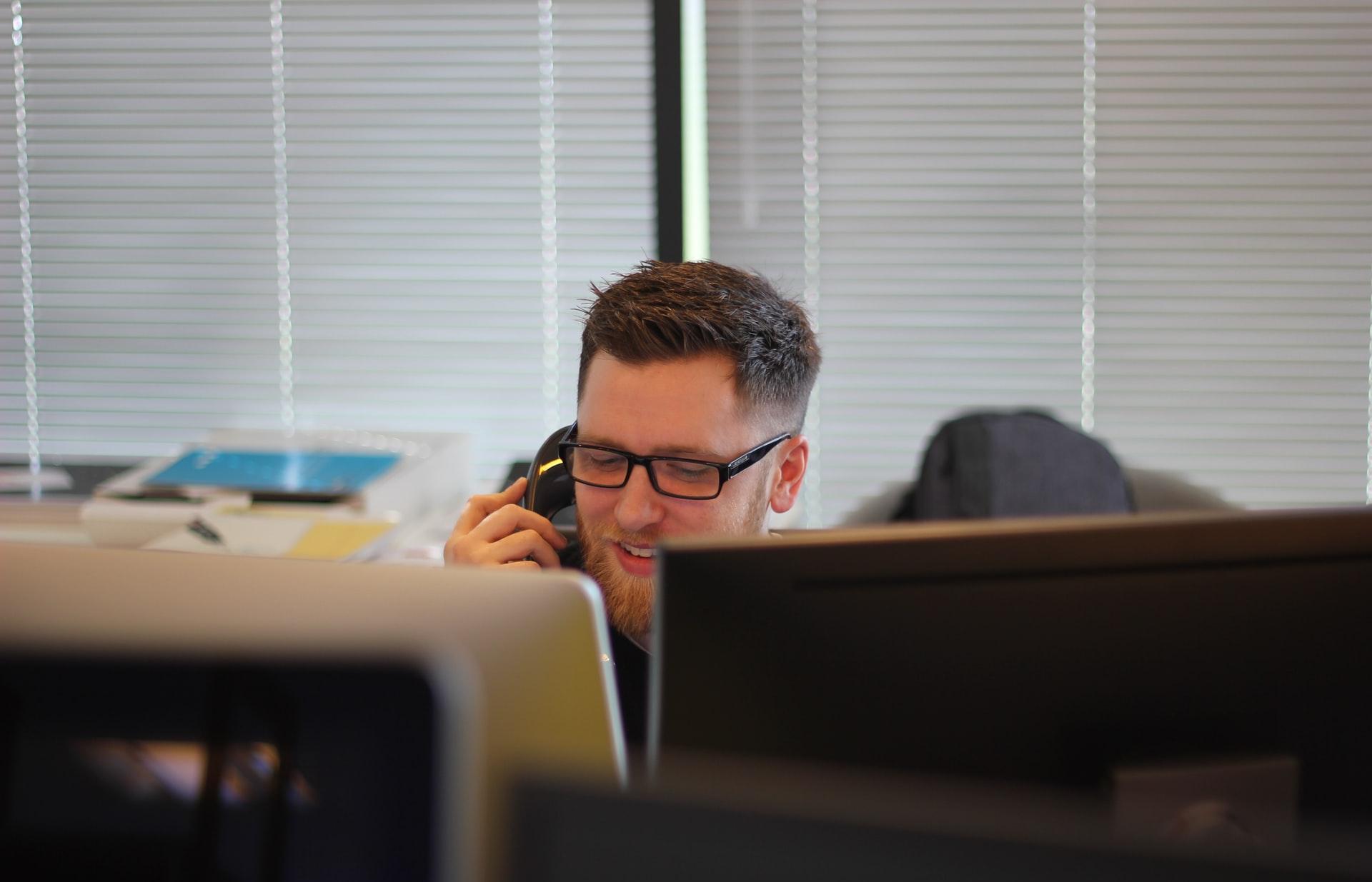 man using IP phone inside room